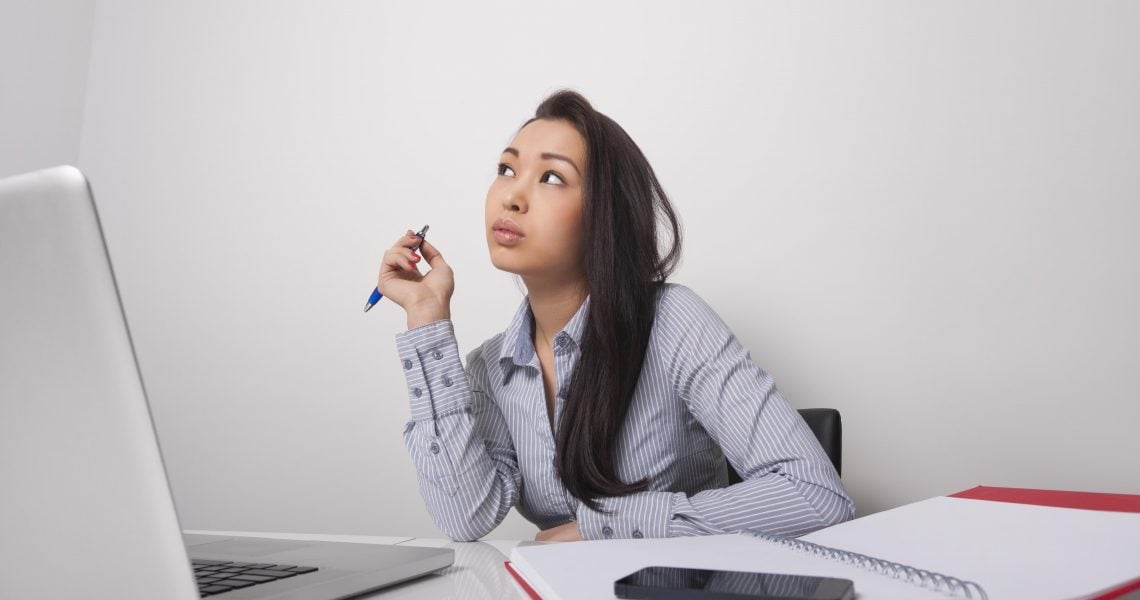 Thoughtful businesswoman sitting at office desk Thoughtful businesswoman sitting at office desk
